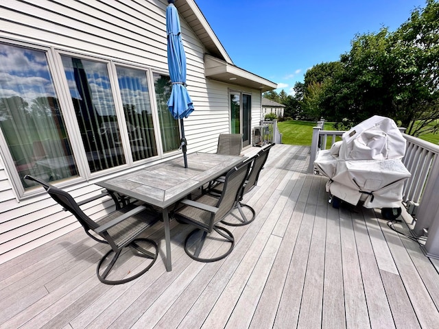 wooden deck featuring a lawn