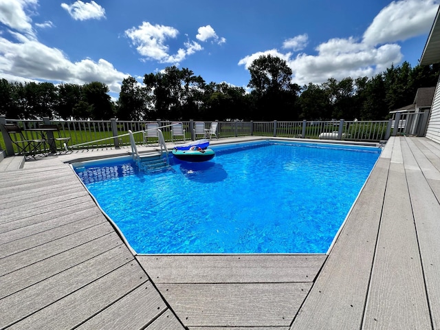 view of swimming pool featuring a wooden deck