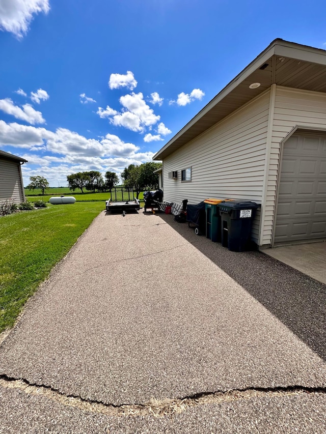 view of home's exterior with a garage and a yard