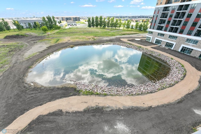 view of swimming pool featuring a water view