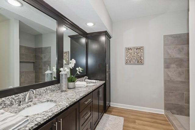 bathroom featuring double sink vanity and hardwood / wood-style flooring