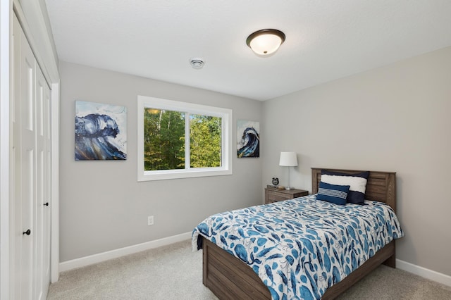 carpeted bedroom featuring a closet