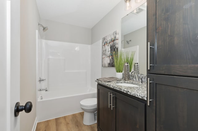 full bathroom with vanity, shower / bath combination, toilet, and hardwood / wood-style floors