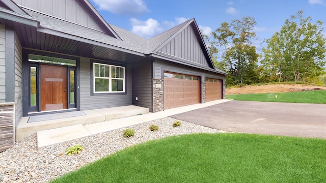 exterior space featuring a garage and a lawn