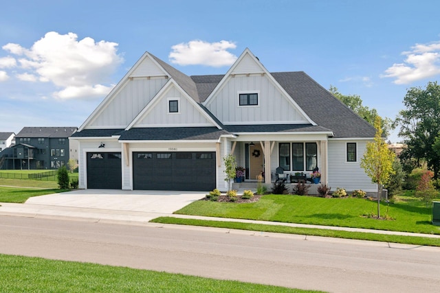 view of front of property with a front yard and a garage