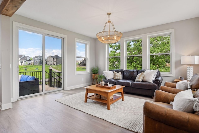 living room with hardwood / wood-style flooring and an inviting chandelier