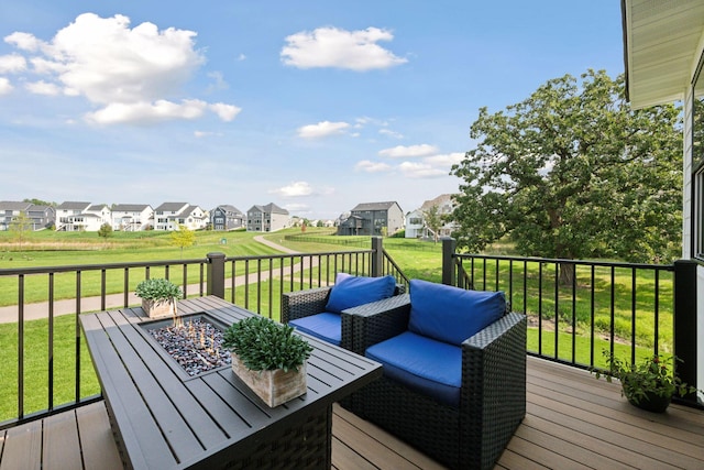 deck with a yard, outdoor dining area, and a residential view