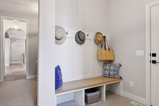 mudroom with visible vents, baseboards, and light tile patterned floors