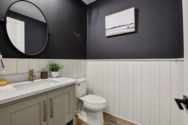 bathroom featuring toilet, hardwood / wood-style floors, and vanity