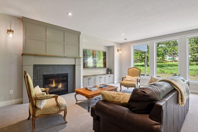 living room with a fireplace, carpet floors, and a healthy amount of sunlight