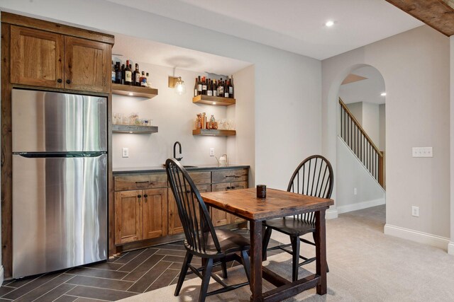 carpeted dining space featuring sink