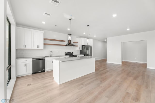 kitchen featuring dishwashing machine, sink, white cabinetry, stainless steel refrigerator with ice dispenser, and decorative light fixtures