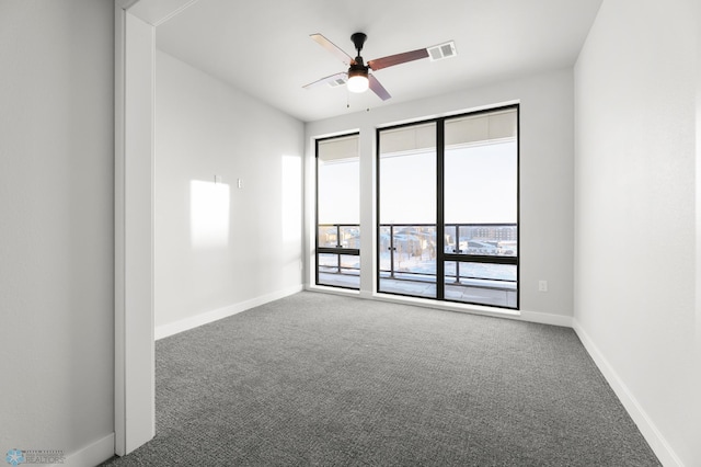 empty room featuring ceiling fan and carpet