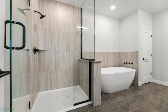 bathroom with separate shower and tub and tile patterned flooring