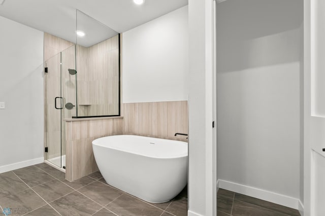 bathroom with tile patterned floors and separate shower and tub