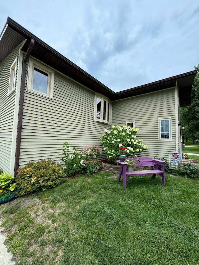 view of side of home featuring a yard