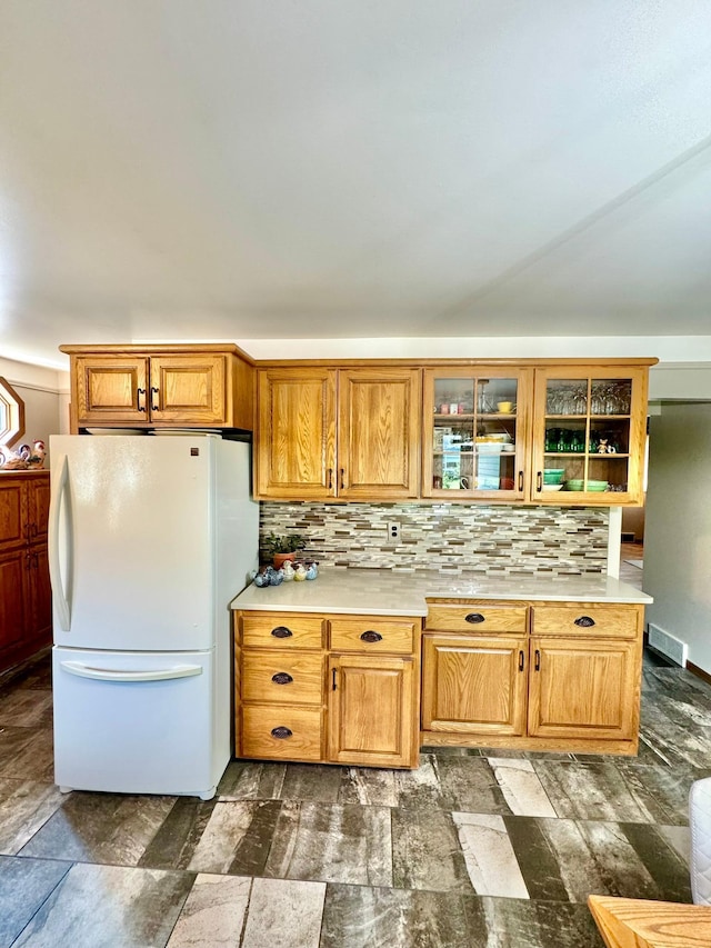 kitchen featuring white fridge and backsplash