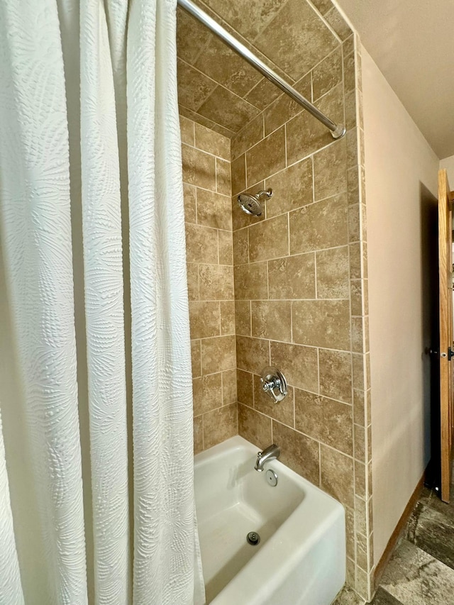 bathroom with shower / bath combo with shower curtain