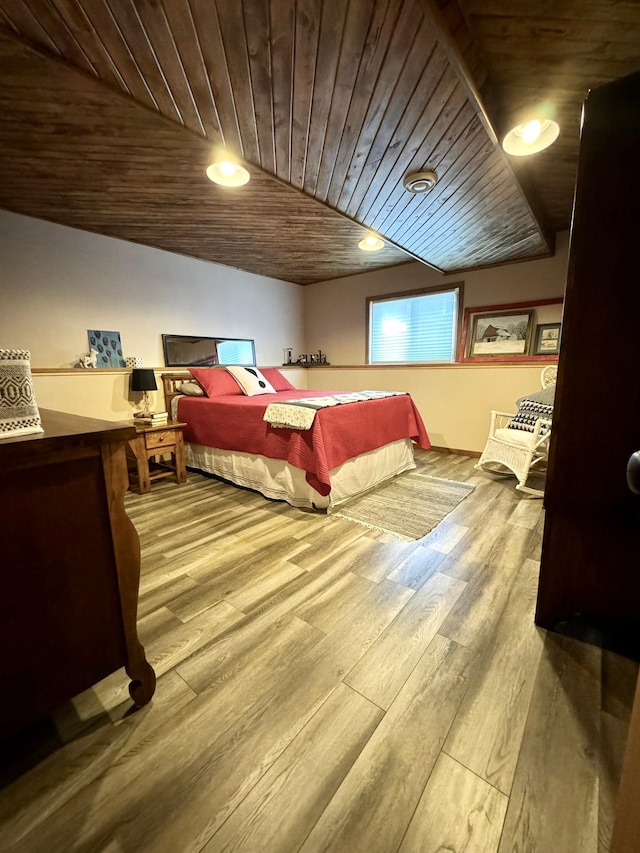 bedroom with wood ceiling, hardwood / wood-style flooring, and vaulted ceiling