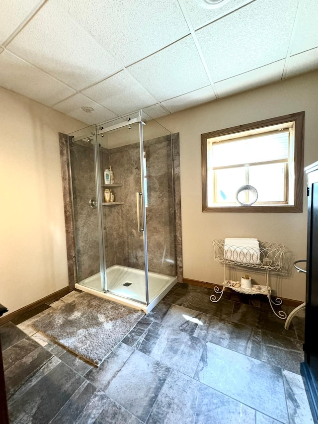 bathroom featuring an enclosed shower and a paneled ceiling