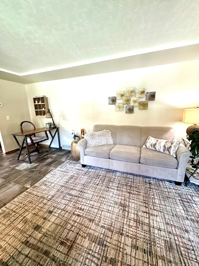 living room with a textured ceiling