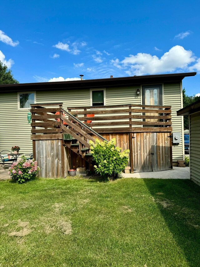 rear view of property featuring a yard