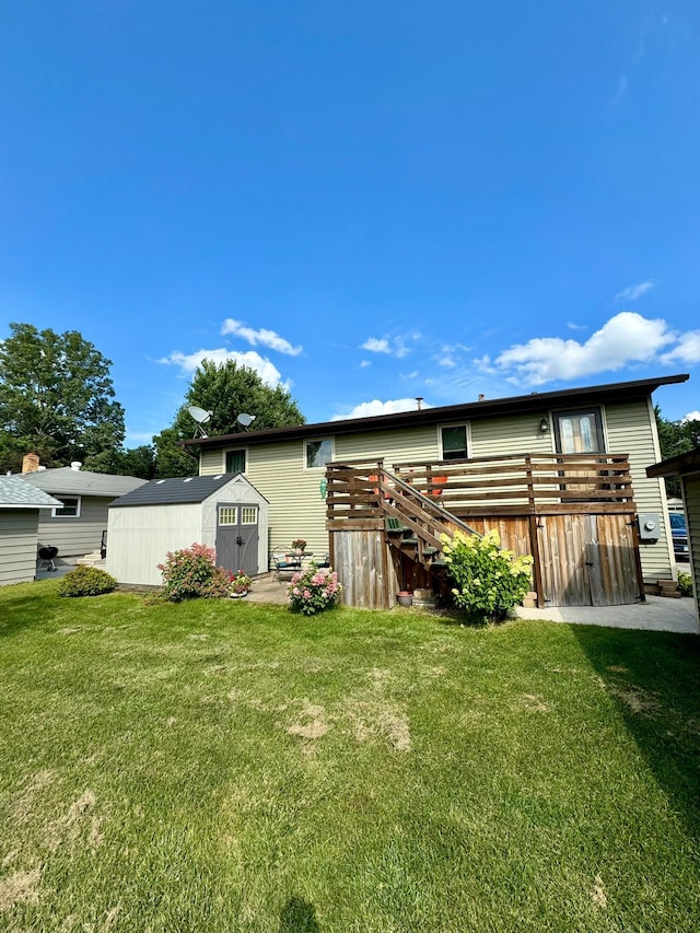 back of property featuring a yard and a storage shed