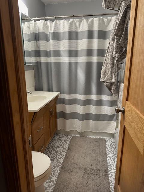 bathroom featuring vanity, toilet, and tile patterned flooring