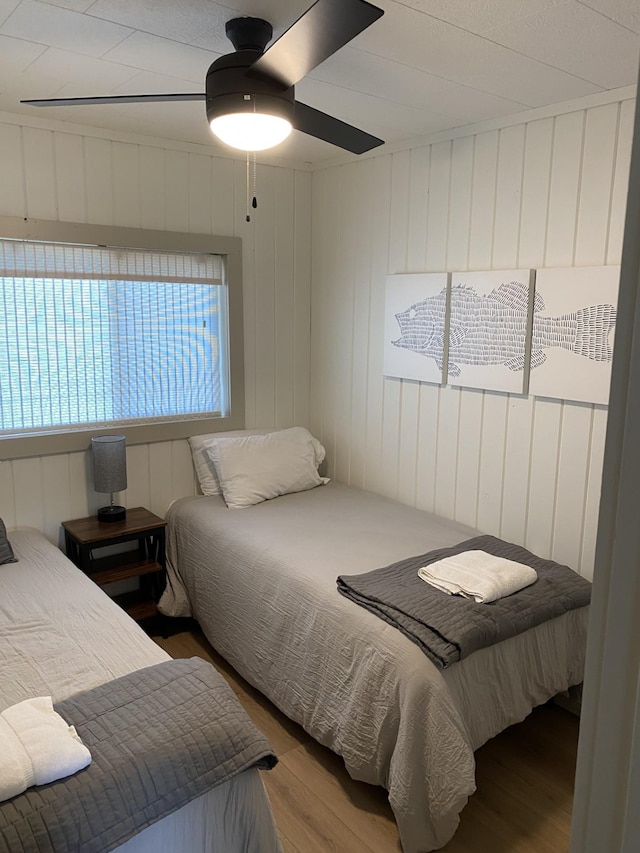 bedroom featuring a ceiling fan and wood finished floors