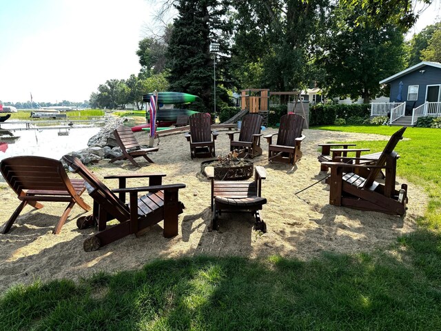 exterior space featuring a fire pit and a lawn