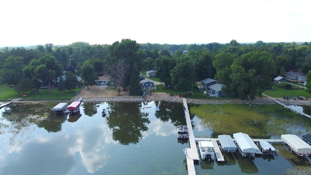 birds eye view of property featuring a forest view and a water view