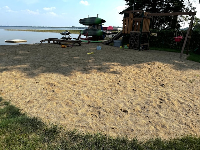 exterior space with a water view and a playground