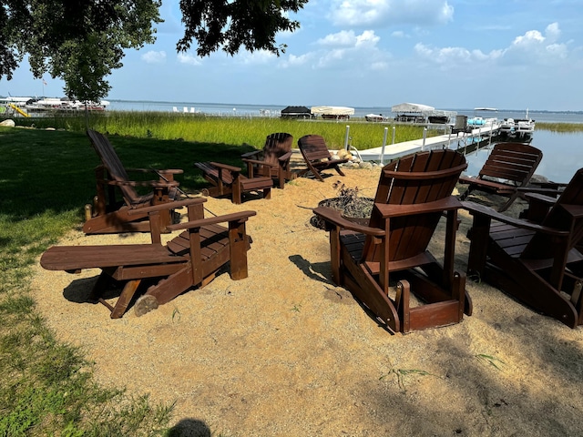 view of yard featuring a dock and a water view