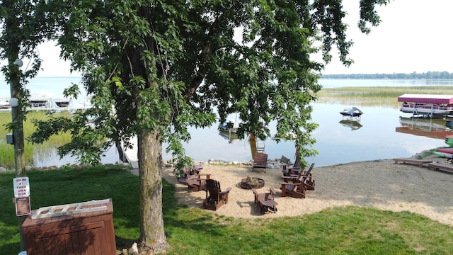 property view of water with an outdoor fire pit