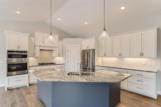 2066 151st Ave NW, Andover, MN 55304 - kitchen featuring lofted ceiling, a sink, a center island with sink, stainless steel appliances, and white cabinets