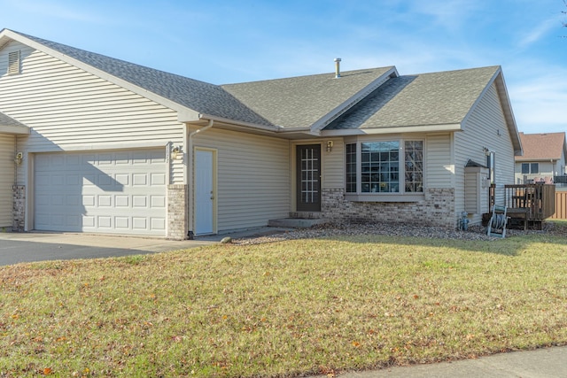 single story home featuring a garage and a front lawn