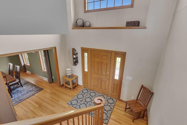 entryway with wood finished floors and baseboards