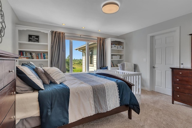 bedroom with light carpet and baseboards