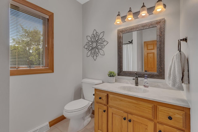 full bath featuring tile patterned flooring, toilet, visible vents, vanity, and baseboards