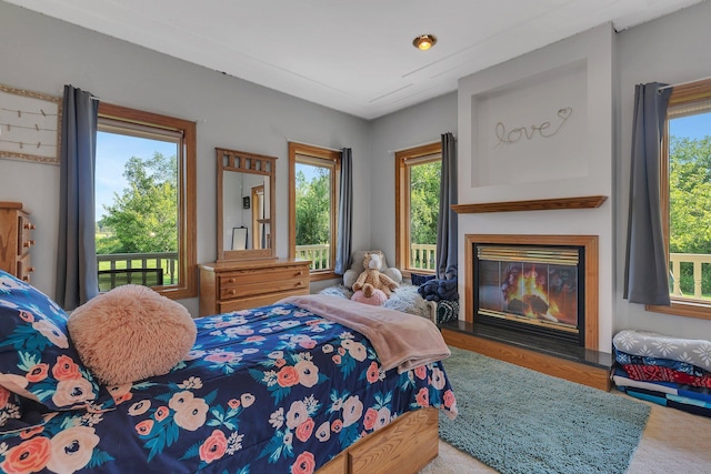 bedroom with a glass covered fireplace