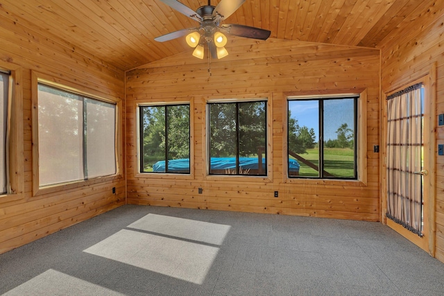 unfurnished sunroom featuring ceiling fan, wood ceiling, and vaulted ceiling