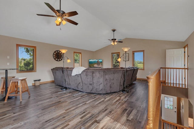 living area with vaulted ceiling, plenty of natural light, and wood finished floors