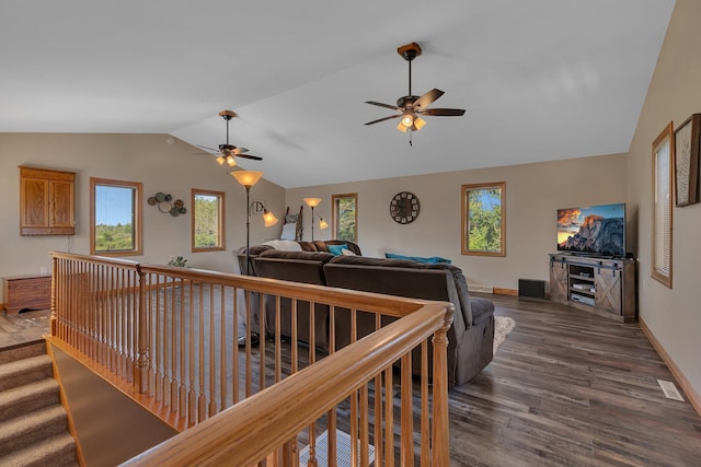 hall featuring dark wood finished floors, vaulted ceiling, and baseboards