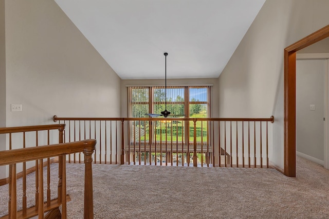 corridor featuring lofted ceiling and carpet floors