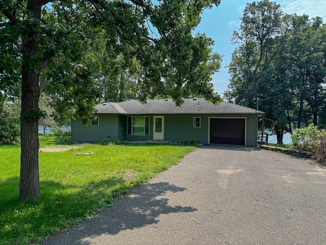 ranch-style home with a garage and a front yard