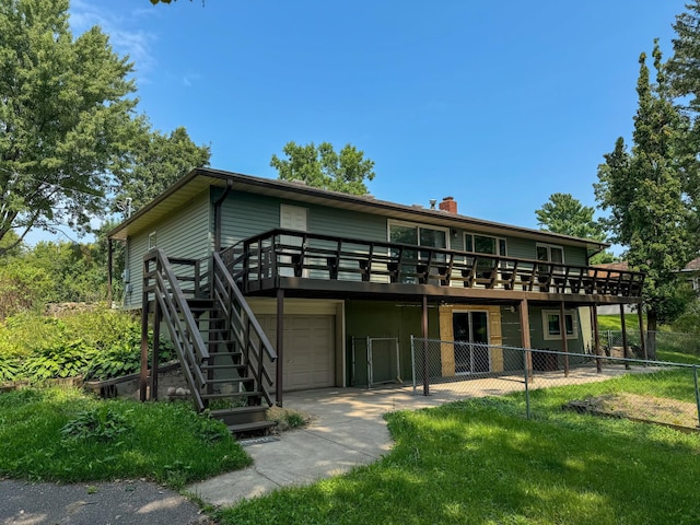 back of house featuring a lawn and a garage