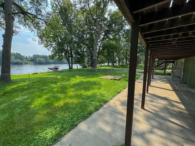 view of yard with a patio and a water view