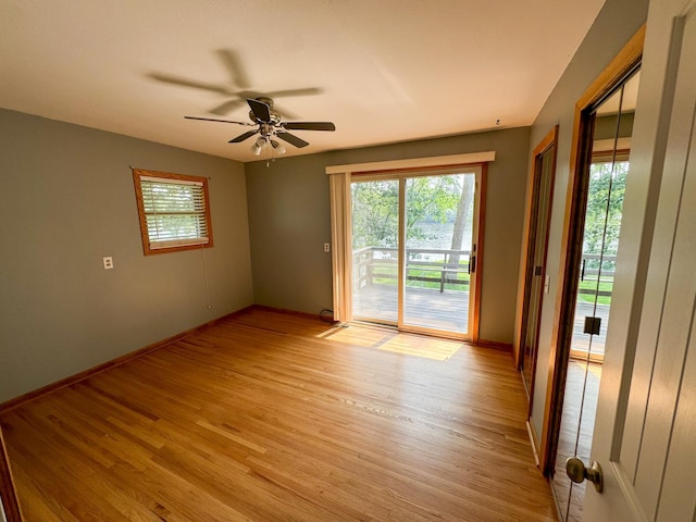 empty room with ceiling fan and light wood-type flooring