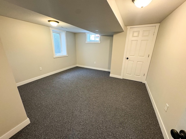 basement with dark colored carpet