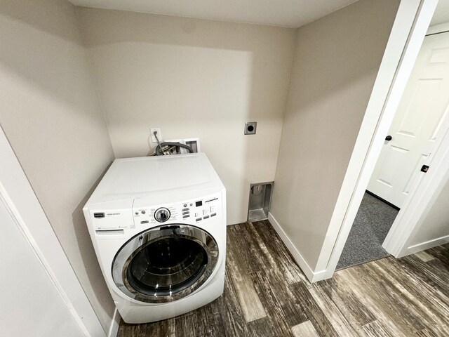 clothes washing area with dark wood-type flooring and washer / dryer